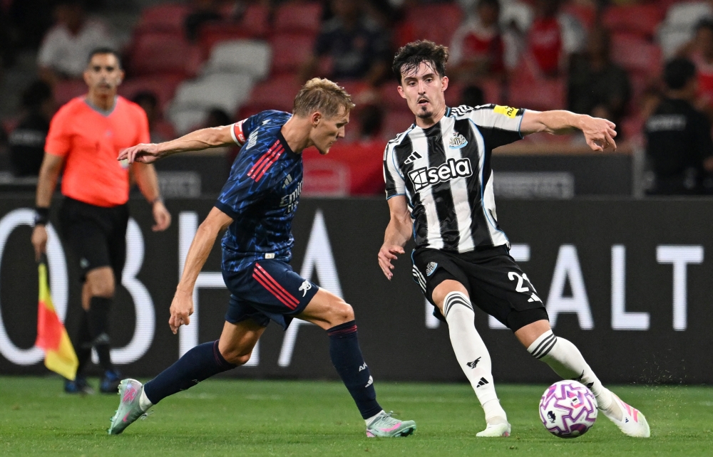 Newcastle United’s Tino Livramento in action with Arsenal’s Martin Odegaard at the National Stadium in Singapore, July 27, 2025. — Reuters pic 