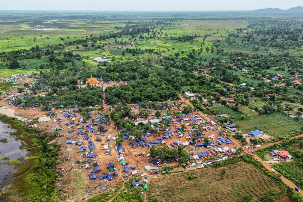 An aerial view shows displaced people seeking shelter near a pagoda in Oddar Meanchey province, after fleeing their homes near the Cambodia-Thailand border July 26, 2025. — AFP pic