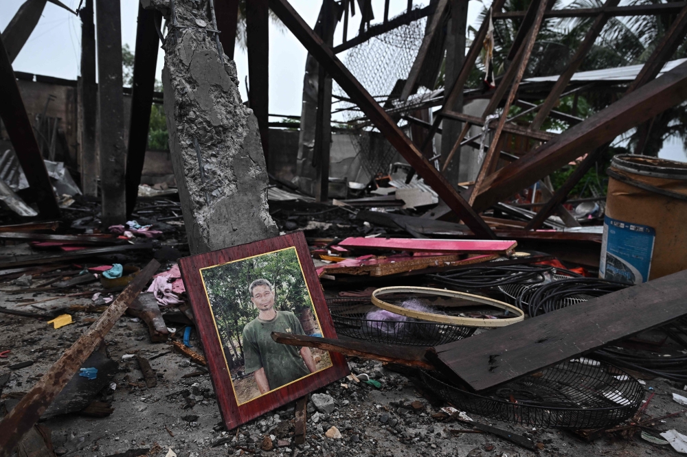 A portrait lies in an evacuated house that was destroyed by fire after being hit by Cambodian artillery that morning, in the Thai border province of Surin on July 27, 2025. — AFP pic