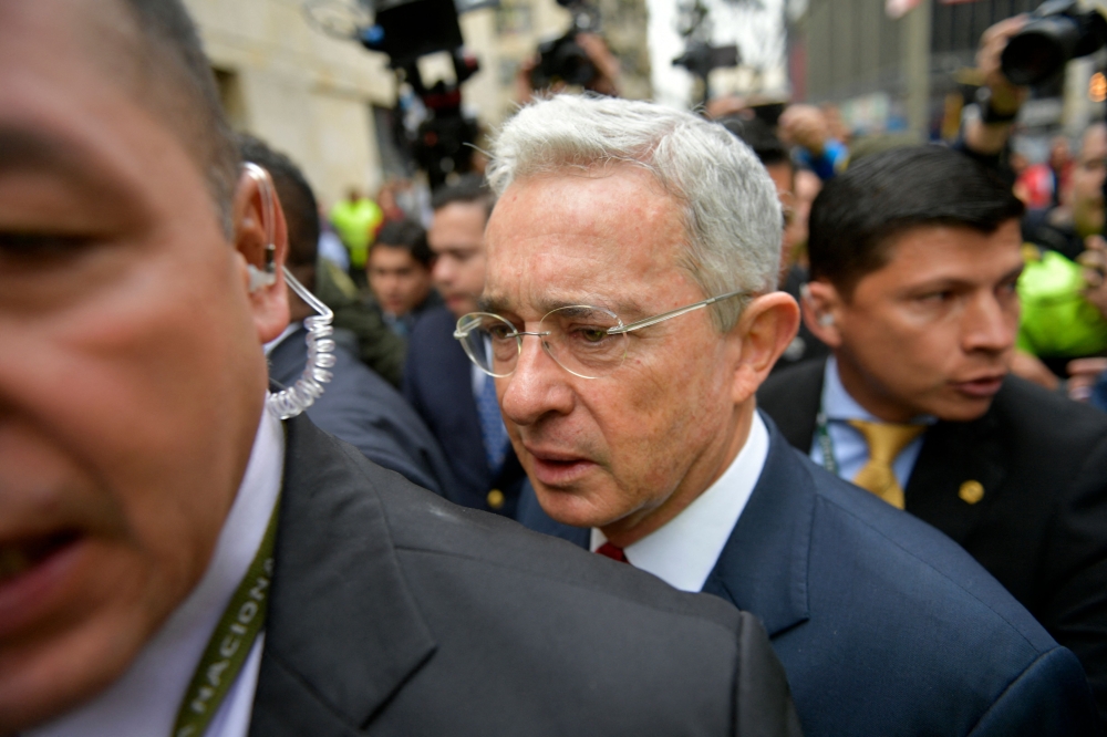 File picture of former Colombian President (2002-2010) and Senator Alvaro Uribe (centre) arriving to the Palace of Justice for a hearing before the Supreme Court of Justice in a case over witness tampering in Bogota, Colombia, on October 8, 2019. A Colombian judge on Monday convicted Uribe of abuse of process and bribery of a public official in a long-running witness tampering case, making him the country’s first ex-president to ever be found guilty at trial. — AFP pic