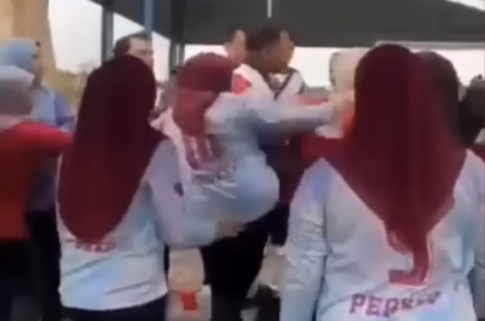 A screen grab shows a woman kicking another during a brawl at the Johor State Sports Carnival on May 24, 2025.