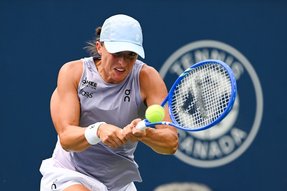 Iga Swiatek (POL) returns the ball to Hanyu Guo (CHN) in second round play at IGA Stadium in Montreal, July 30, 2025. — David Kirouac-Imagn Images pic via Reuters 