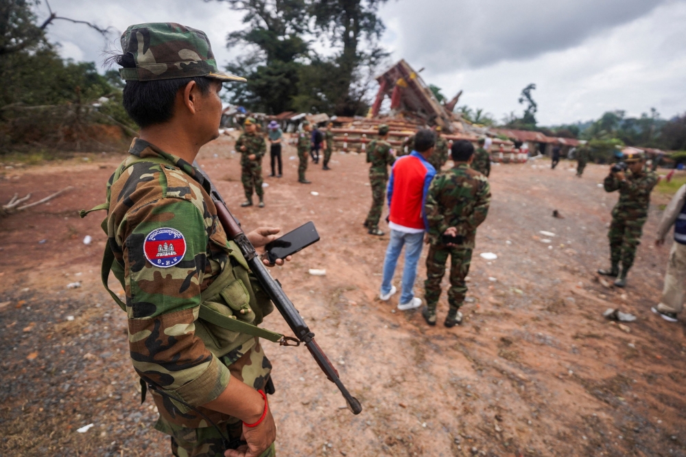 A military personnel takes position at the closed An Ses border checkpoint, also known as Chong Arn Ma in Thai, during an inspection by foreign military attaches from major powers and Asean member countries, along with diplomats from 13 countries, after the leaders of Cambodia and Thailand agreed to a ceasefire on Monday effective midnight, in a bid to bring an end to their deadliest conflict in more than a decade. — Reuters pic
