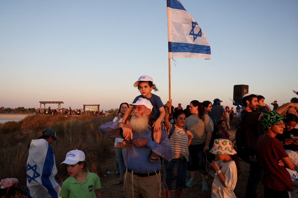 Israeli right wing activists take part in a rally organised by settlers groups to promote Israel’s resettling in Gaza, on the Israeli side of the Israel-Gaza border,  July 30, 2025. — Reuters pic 