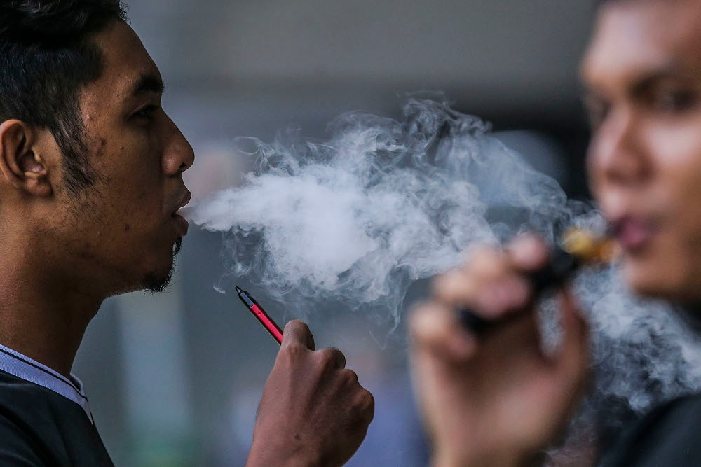 An undated file photograph shows people using electronic cigarettes in Kuala Lumpur. — Picture by Hari Anggara 