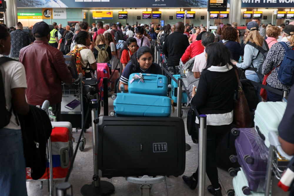 Passengers wait in line at Heathrow Airport, after radar failure led to the suspension of outbound flights across the UK, in Hounslow, London, Britain, July 30, 2025. — Reuters pic 