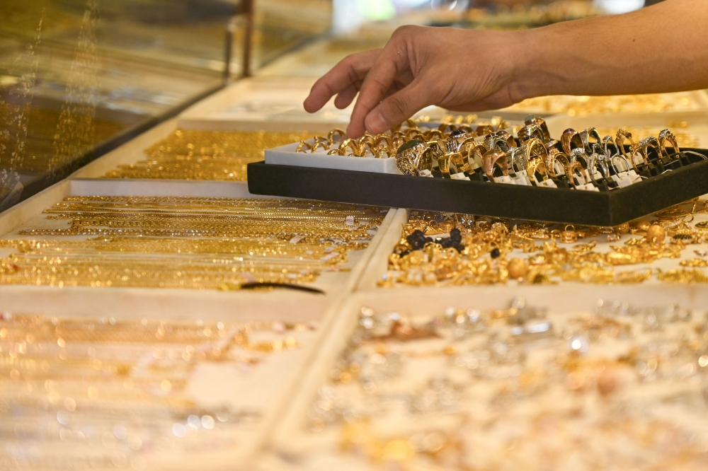 Worldwide demand for gold coins and bars fell six percent in the second quarter over the previous three months, the report said.  — AFP file pic