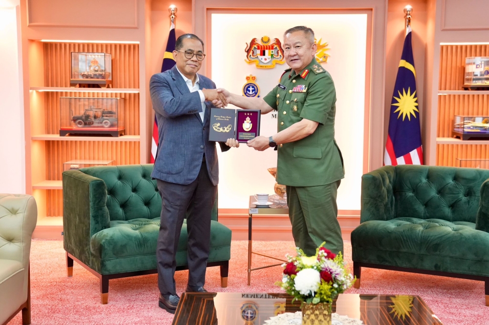 Defence Minister Datuk Seri Mohamed Khaled Nordin presents a plaque to Lt-Gen Datuk Johnny Lim Eng Seng at Wisma Pertahanan in Kuala Lumpur on July 30, 202. — Khaled Nordin/Facebook pic