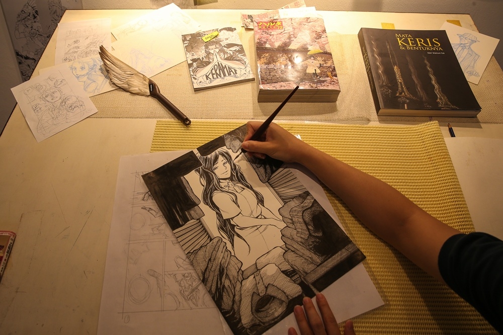 An artist from Rise Production hand-drawing a character. — Picture by Yusof Mat Isa