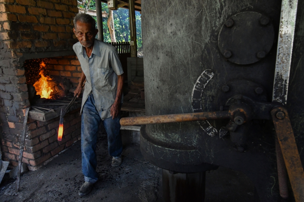 A knife crafted by Fauzi Yusoff undergoes the burning process before being forged at his workshop in Kampung Hutan Pasir, Ketereh. — Bernama pic