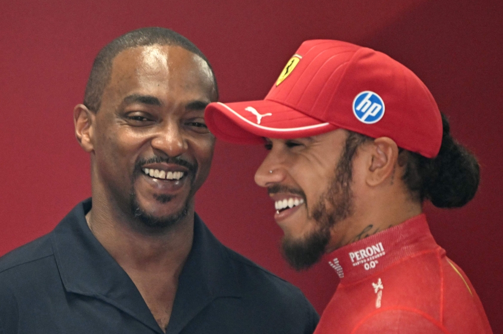 Ferrari’s British driver Lewis Hamilton (right) talks with US actor Anthony Mackie prior to the third practice session ahead of the Formula One Hungarian Grand Prix at the Hungaroring circuit in Mogyorod near Budapest, Hungary, on August 2, 2025. — AFP pic