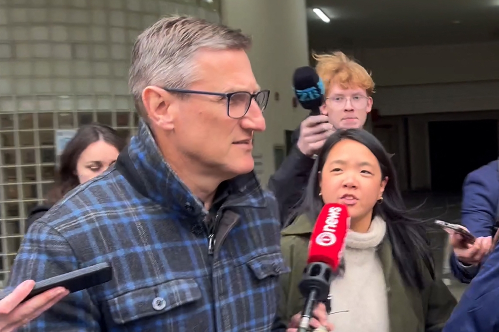 This frame grab taken from AFPTV footage on August 4, 2025 shows New Zealand's former deputy police commissioner Jevon McSkimming (front) leaving court after he was charged with possessing child sexual exploitation and bestiality material in Wellington. — AFP pic