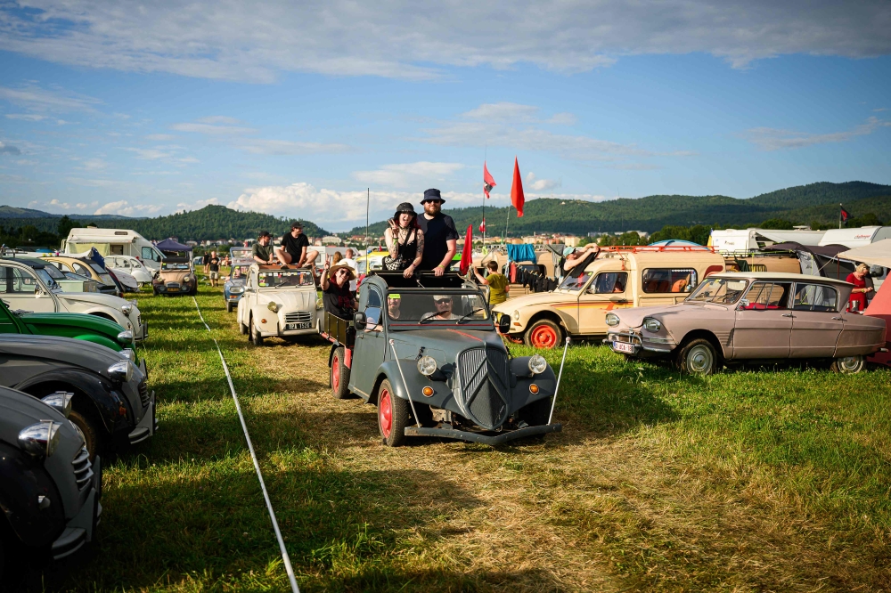 2CV fans drive their vehicle through a camp as they attend the 25th World Meeting of 2CV Friends in Postojna, Slovenia on July 30, 2025. — AFP pic
