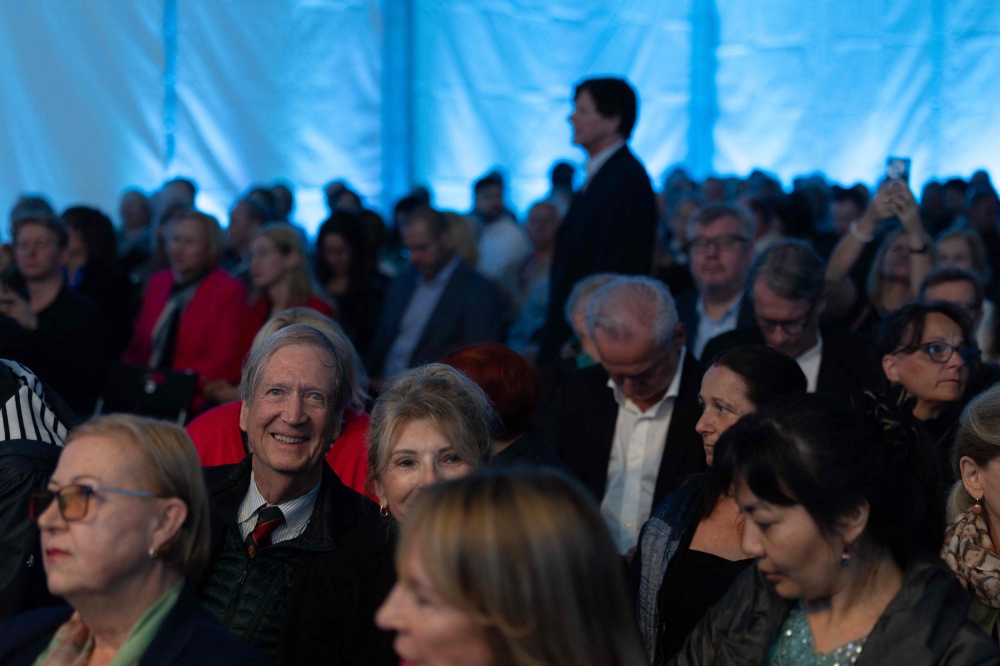 Mike Righton (2nd left), 73, a retiree from Texas, waits in his seat in the audience for the opening concert to begin on the first day of the 80th Duszniki International Chopin Piano Festival in Duszniki Zdroj, south-western Poland, August 2, 2025. — AFP pic