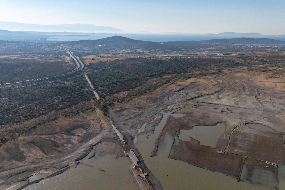 This aerial photograph shows a section of the old Izmir-Cesme highway emerging after the water level dropped at the Alacati Kutlu Aktas Dam in Izmir, on July 30, 2025. — AFP pic