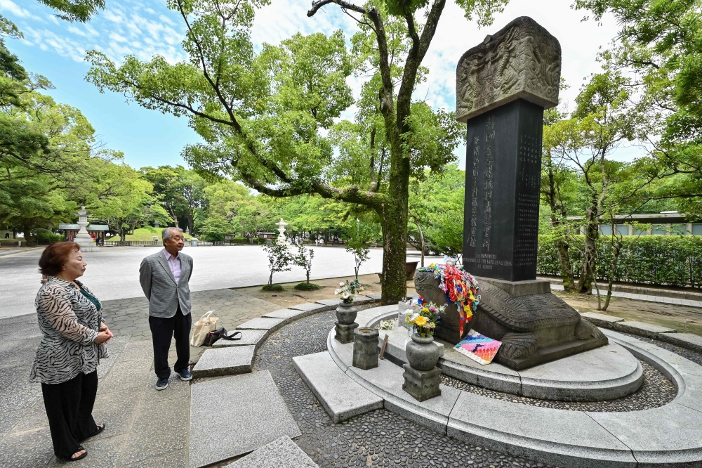 This photo taken on June 26, 2025 shows Kim Hwa-ja (front left), an ethnic Korean who is also an atomic bomb survivor, or ‘hibakusha’, and Kwon Joon-oh (2nd left), whose mother and father were also survivors, as they visit the ‘Monument in Memory of the Korean Victims of the A-bomb’, following an interview with AFP near the Peace Park Memorial in the city of Hiroshima, Hiroshima prefecture. — AFP pic 