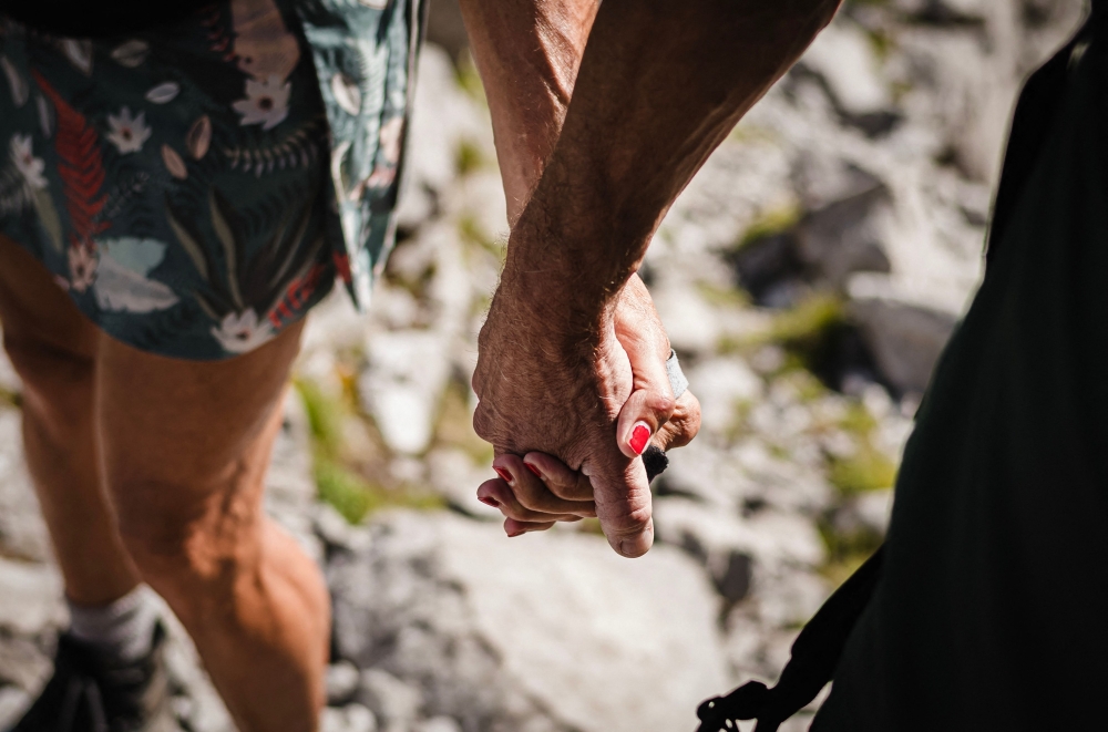 Patrick and Cathy, both 58 years old, walk hand in hand to the Wandflue peak, Bernese Alps, above Jaun of the Canton of Fribourg August 3, 2025. — AFP pic 