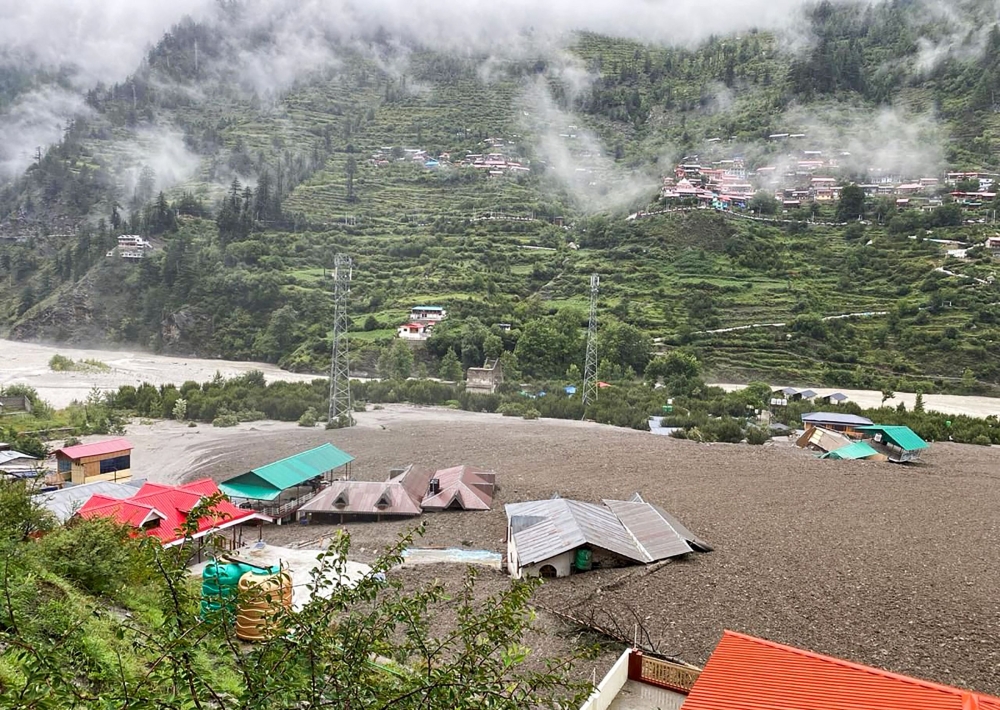 This handout photograph taken on August 5, 2025 and released by the Indian Army shows residential buildings partially submerged in sludge after a cloudburst caused a massive mudslide in India’s Uttarakhand state. — Indian Army handout pic via AFP