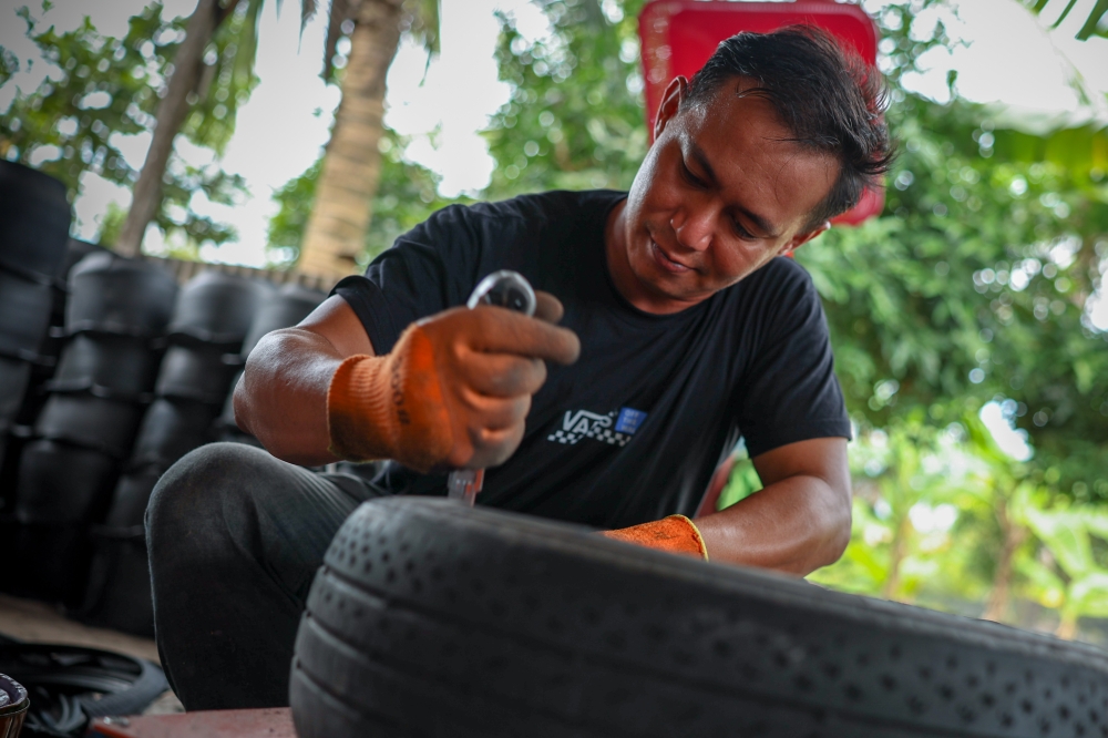 Entrepreneur Muhammad Akhmal Adib, 33, turned a hobby making flower pots during the 2020 movement control order into a full-time business that also promotes recycling. — Bernama pic