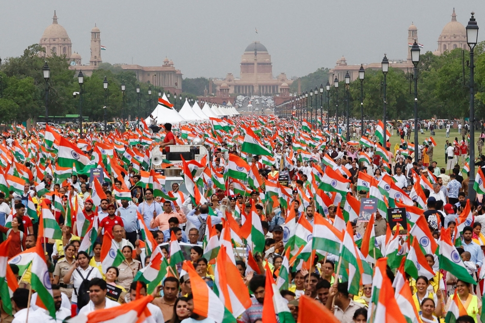 People wave Indian flags in support of the Indian Armed Forces, following the ceasefire announcement between India and Pakistan, in Delhi May 13, 2025. — Reuters pic
