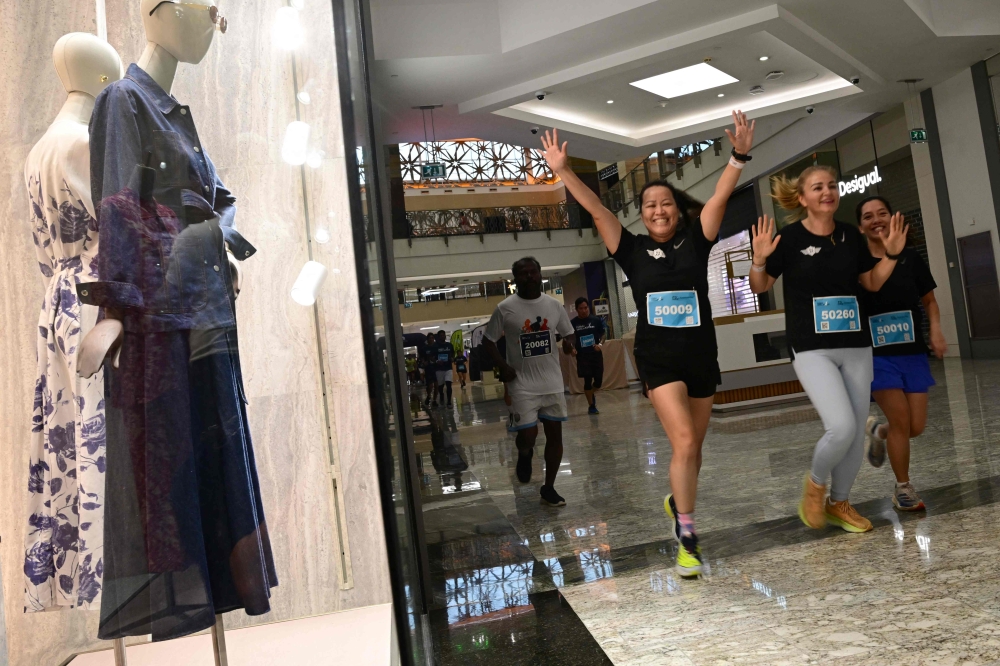 Participants ran and walked past closed stores along vacant, marbled halls. — AFP pic