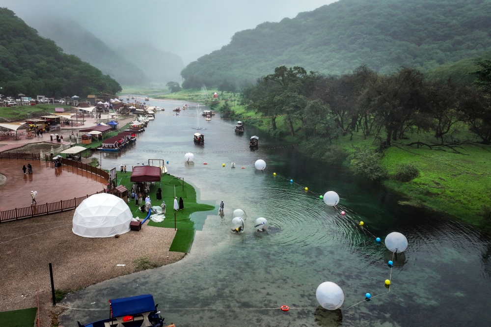 An aerial picture shows a touristic spot on the Wadi Darbat lake in the region of Dhofar, near Oman’s Salalah city on July 25, 2025. The overwhelming majority of Omanis speak Arabic, but in the mountainous coastal region of Dhofar bordering Yemen, people speak Jibbali, also known as Shehri. — AFP pic 