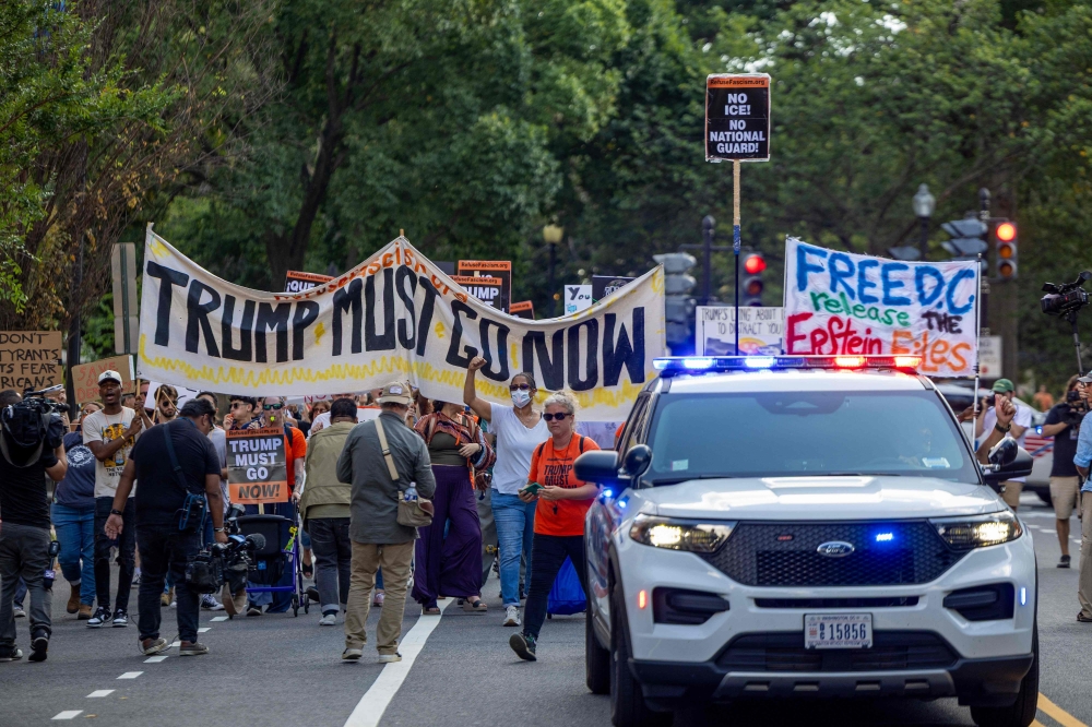 Protesters gather at Dupont Circle after the morning press conference by President Donald Trump on August 11, 2025 in Washington, DC. Trump announced he will use his authority to place the DC Metropolitan Police Department under federal control and deploy the National Guard to assist in crime prevention in the nation’s capital. — Getty Images pic via AFP 