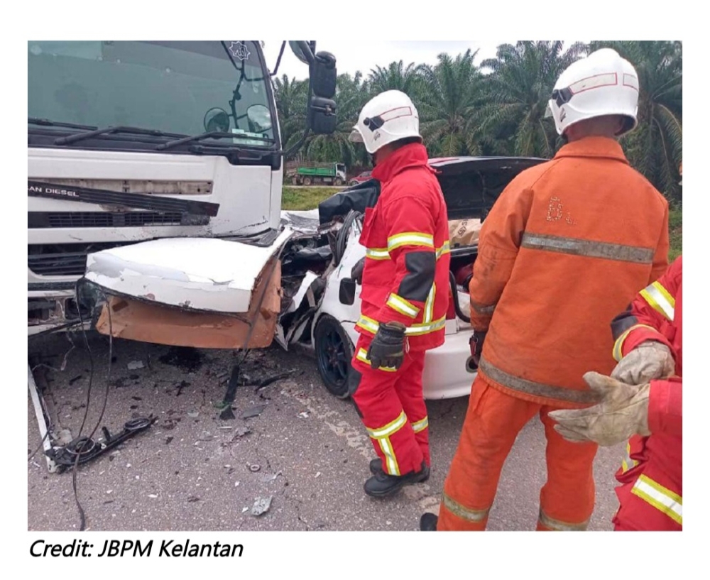 In the 9.15 am incident, four people, including two children, were killed and another was seriously injured after their car collided with a trailer lorry on the main road at Felda Chiku 1, Gua Musang.— Picture via Facebook/JBPM Kelantan