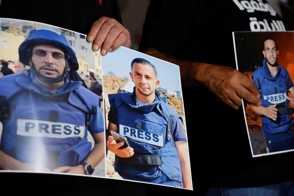 Palestinians protest against the killing of journalists in Gaza, in Ramallah in the Israeli-occupied West Bank, August 11, 2025. A recent Israeli strike killed four Al Jazeera journalists and two freelancers, the news channel said Tuesday, clarifying that four of the six dead were staff and not five as initially reported. — Reuters pic 