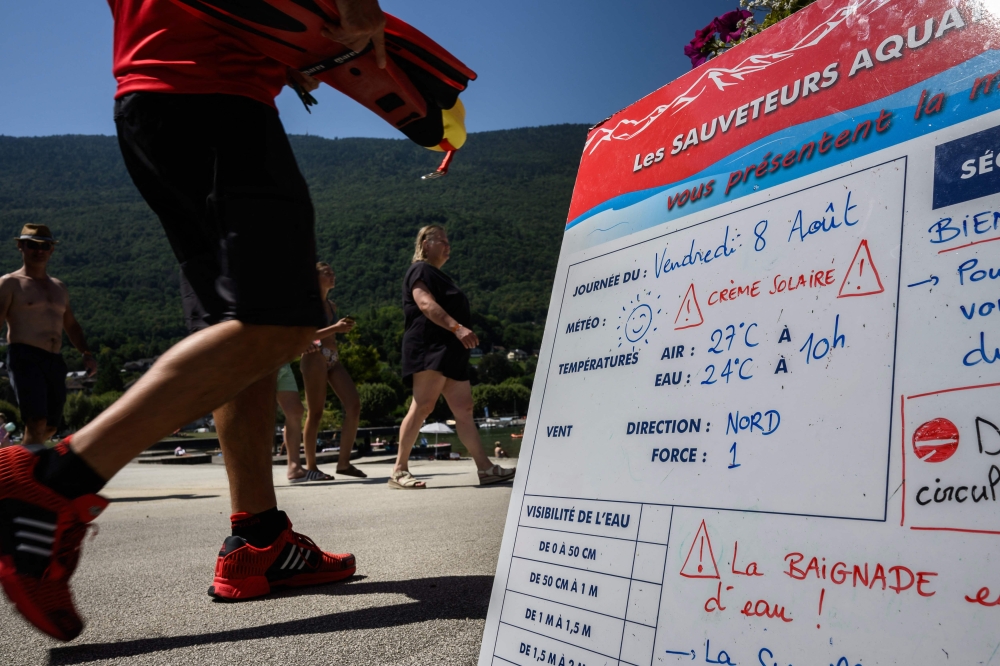 A sign warning people about meteorological and water information is seen at the beach of Le Bourget lake in Le Bourget-du-Lac, central eastern France, on August 8, 2025. — AFP pic