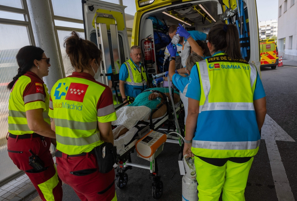 Madrid’s Emergency Medical Service workers transfer a prisoner from Valdemoro prison to Infanta Elena Hospital after he suffered heatstroke in Valdemoro, amid a heatwave, on August 11, 2025. — AFP pic