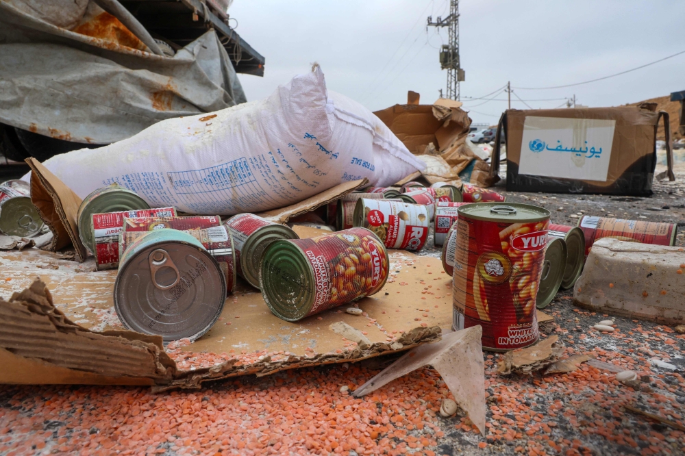 Damaged humanitarian aid for Palestinians in Gaza lies scattered on the ground next to broken-down trucks near the border with the Gaza Strip, close to the Kissufim crossing in southern Israel August 13, 2025. — AFP pic 