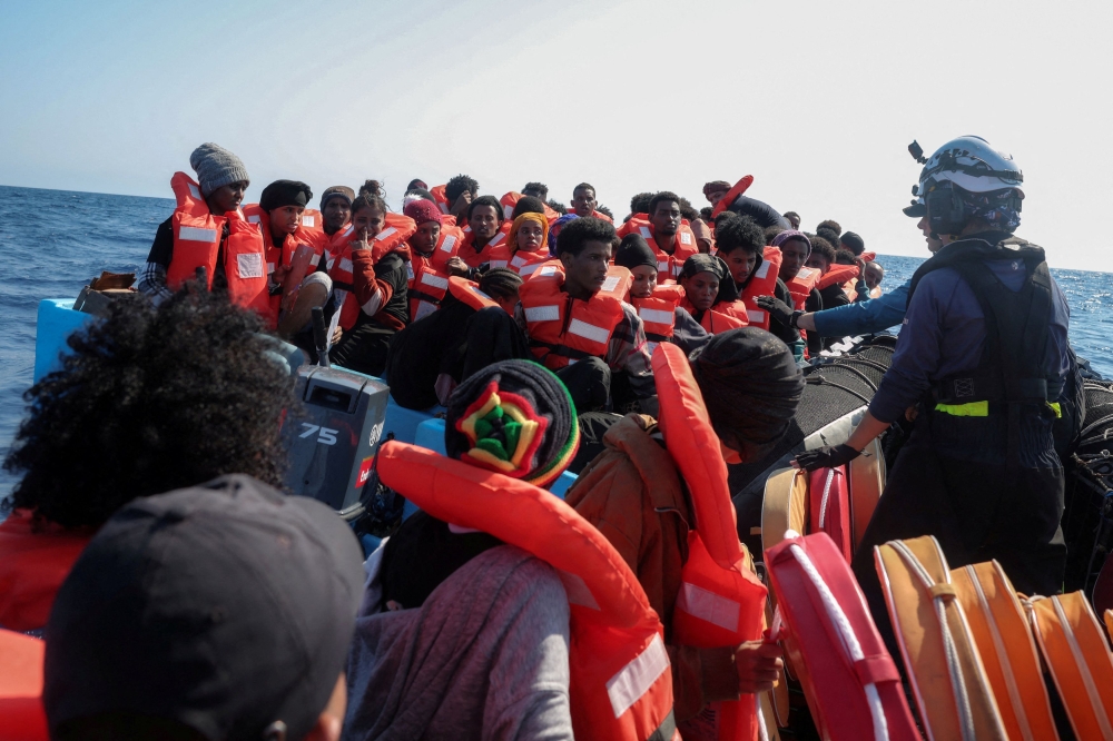 Crew of the migrant search and rescue ship Sea-Watch 5, operated by the German NGO Sea-Watch, carry out a rescue operation for migrants aboard an overcrowded boat in the Search and Rescue (SAR) zone in the central Mediterranean, off Libya, August 11, 2025. — Reuters pic  