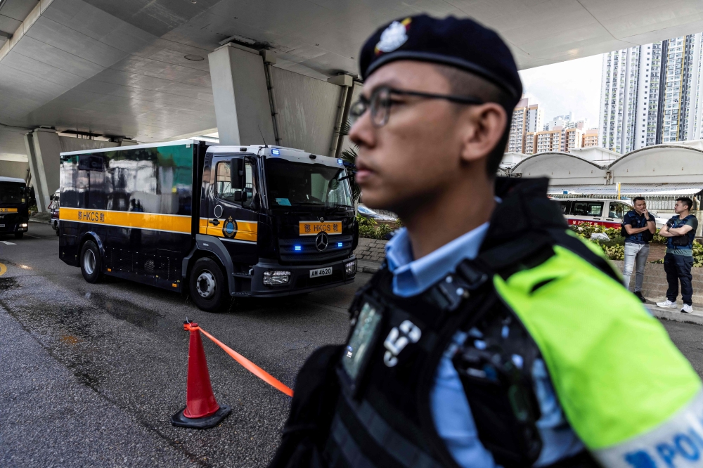 A correctional services van (left) holding Jimmy Lai arrives at the West Kowloon court after Hong Kong media mogul Jimmy Lai arrived for his national security trial in Hong Kong on August 15, 2025. — AFP pic 