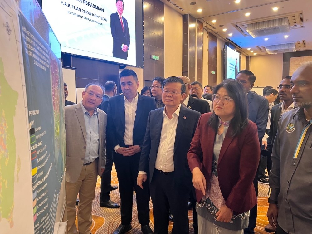 Penang chief minister Chow Kon Yeow looking at a map detailing the land use of the island under the draft local plan. — Picture by Opalyn Mok