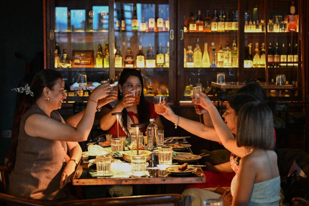 Women enjoy drinks at Barc, a cocktail bar and restaurant in Kathmandu July 2, 2025. — AFP pic