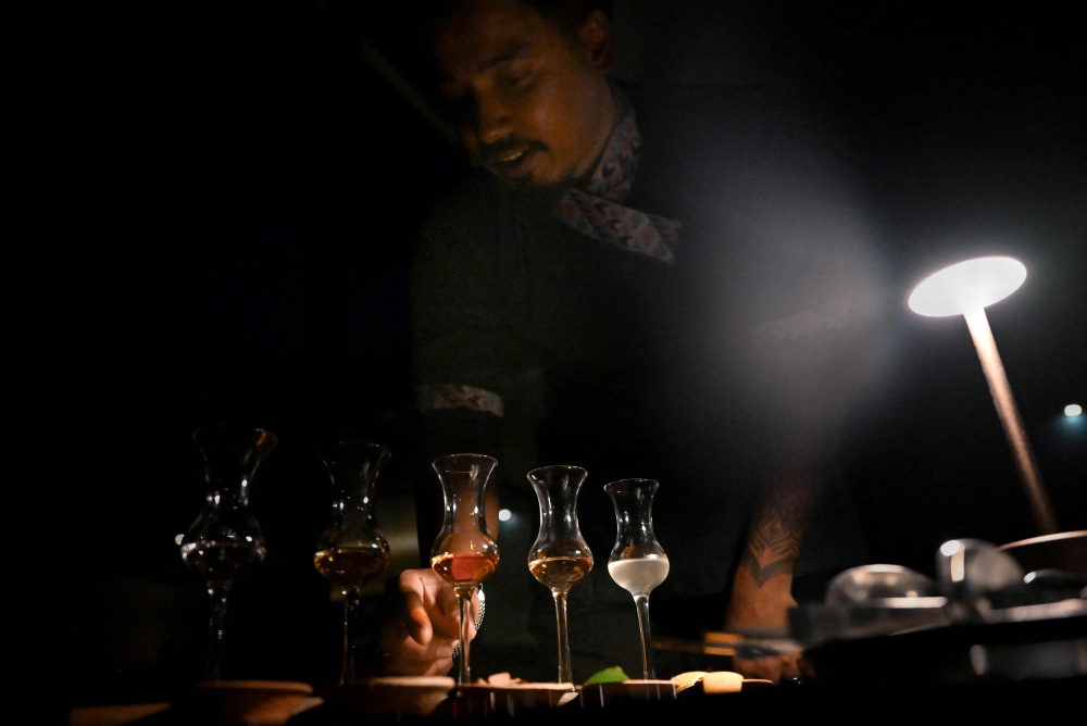 A bartender serves Benedictine, a french liqueur at Barc, a cocktail bar and restaurant in Kathmandu July 2, 2025. — AFP pic