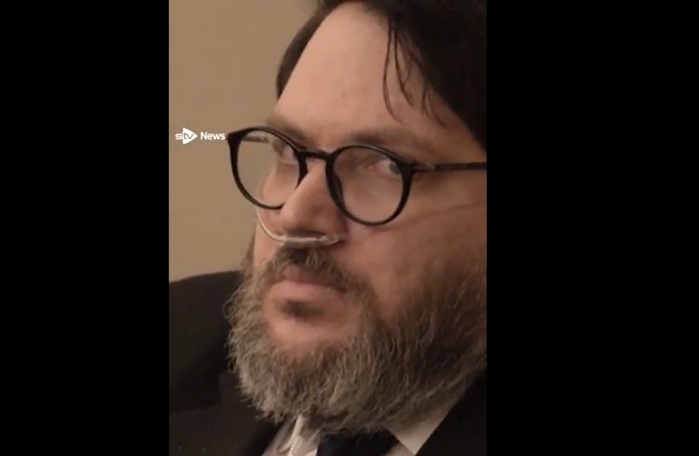 Nicholas Rossi, 38, was found guilty of the 2008 sexual assault of his then-girlfriend by a jury in Salt Lake City on Wednesday. Rossi, using the name Nicholas Alahverdian, had earlier faked his own death, creating an obituary stating he had died of non-Hodgkin’s lymphoma. — Screengrab from STV News