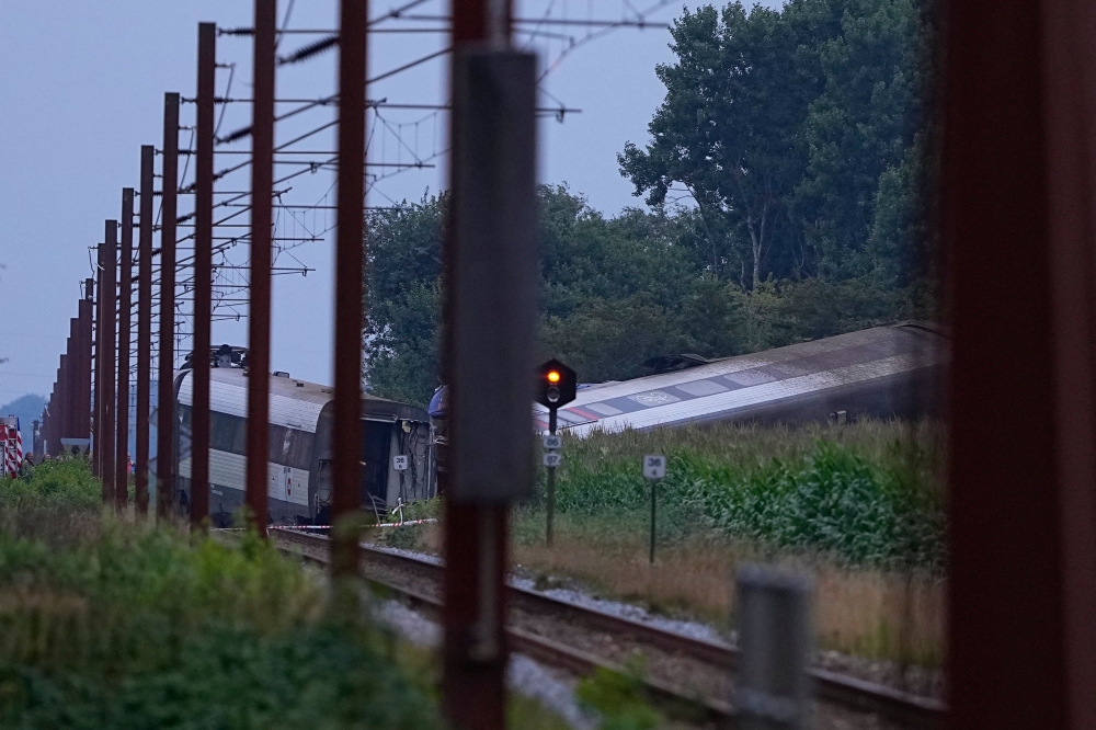 The passenger train derailed in an accident on its way to Soenderborg at the village of Bjerndrup between Kliplev and Tinglev is pictured in south-western Denmark, on August 15, 2025. One person was killed and several others injured in Denmark on August 15, 2025 in a collision between a train and a farm vehicle, police said. — Ritzau Scanpix pic via AFP