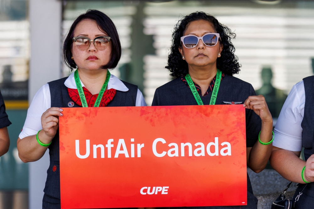 Air Canada flight attendants, represented by the Canadian Union of Public Employees (CUPE) hold a picket at one of four airports to highlight their pay demands in contract negotiations with Canada's largest airline, outside Toronto Pearson International Airport in Mississauga, Ontario August 11, 2025. — Reuters pic 