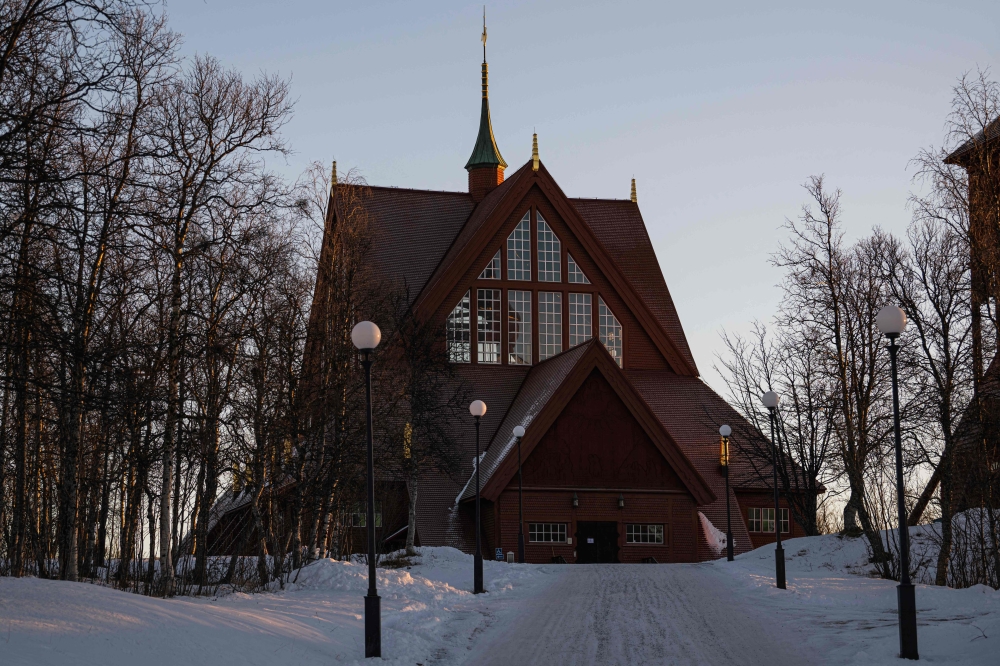 The iconic large red wooden church, considered one of Sweden’s most beautiful buildings, is pictured near the old city centre of Sweden’s northern town, Kiruna, in Lapland. — AFP pic