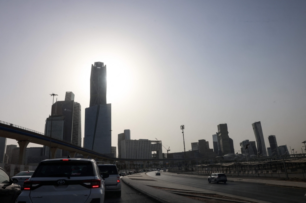 Commuters drive along a road in the King Abdullah Financial District (KAFD) in Riyadh on August 14, 2025, during the soaring summer heat. In arid Saudi Arabia, summer temperatures regularly reach 50C, leaving streets empty for much of the day. — AFP pic