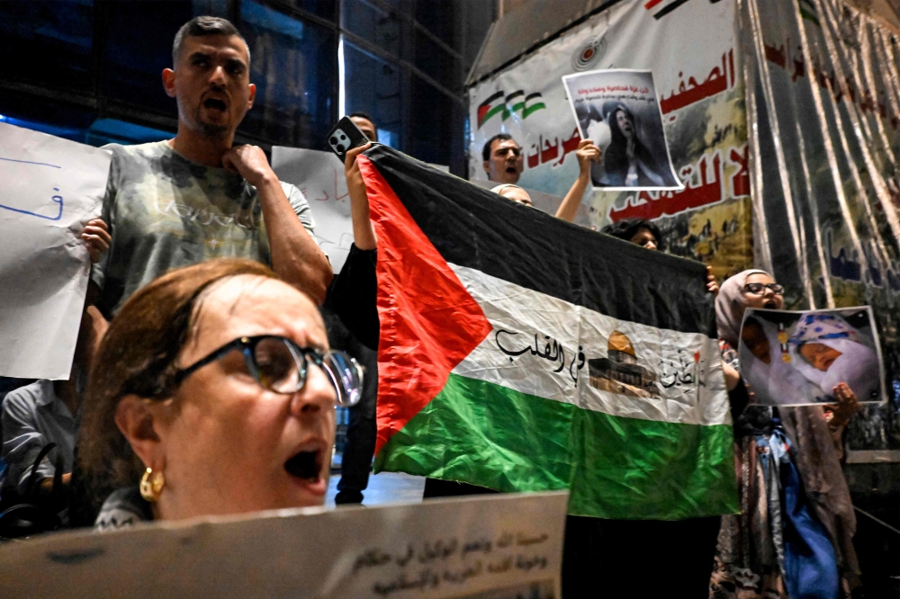 Demonstrators chant slogans during a protest in solidarity with journalists in the Gaza Strip and condemning the killing of Al Jazeera journalists days earlier, organised by journalists outside Egypt’s Press Syndicate in Cairo on August 13, 2025. — AFP