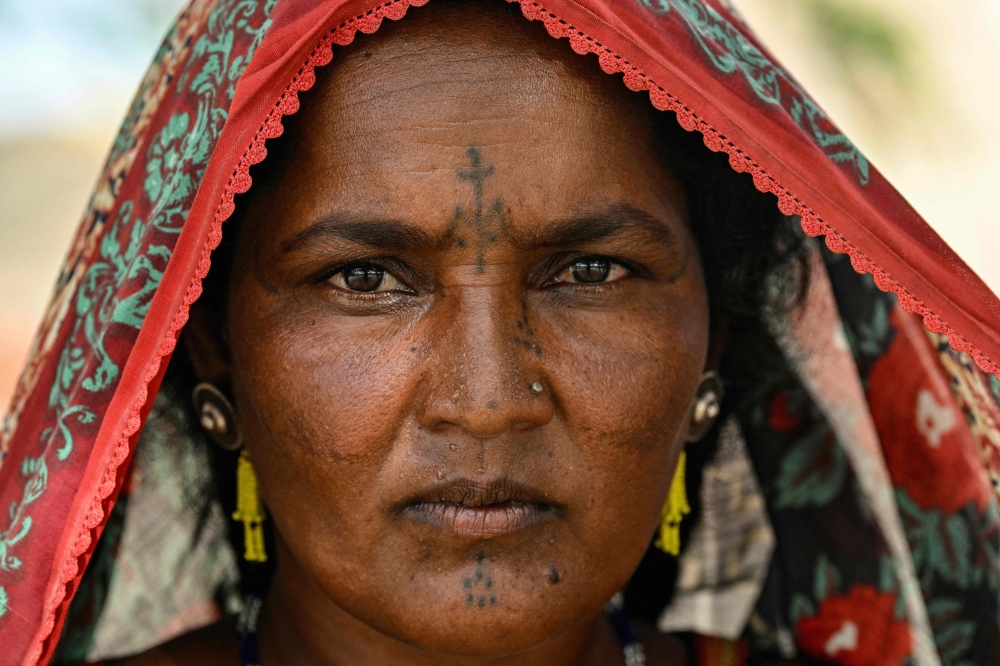 This photograph taken on July 15, 2025 shows Aklan Jogi, posing for the camera as she adorns an indigenous tattoo inked on her face at the Sodo Jogi Colony in Umerkot, a Hindu-majority district in Pakistan. — AFP pic 