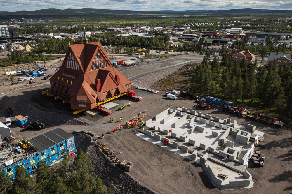 This aerial view shows the wooden Kiruna Church as it arrives at its final location, after a two-day relocation, from the old town to the new city centre, in Kiruna, northern Sweden, August 20, 2025. — AFP pic