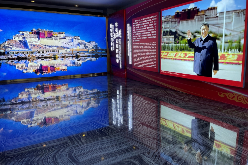 A picture of Chinese President Xi Jinping is seen next to an image of the Potala Palace in Lhasa, Tibet Autonomous Region, at an exhibition at the foreign ministry building in Beijing November 10, 2021. — Reuters pic