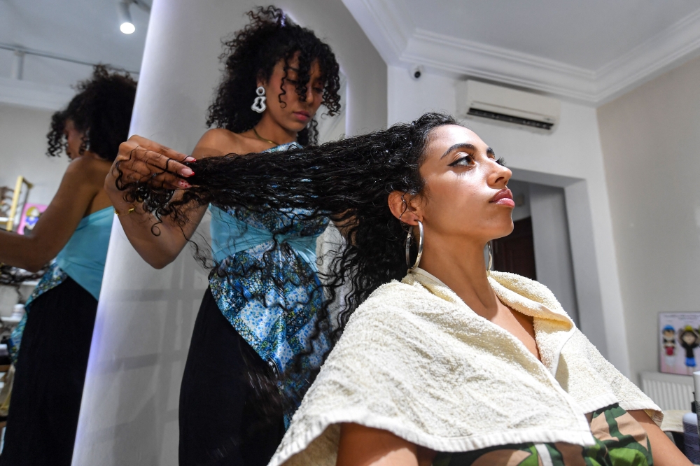 A client has her hair styled at a beauty salon in Tunis July 28, 2025. — AFP pic