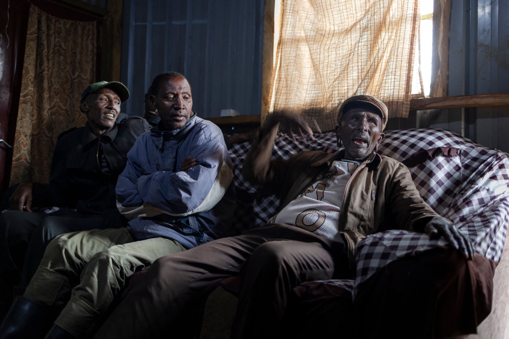 Winston Memusi (right), the vice-chairman of the Ogiek People Development Program (OPDP), sits with other community members in a rented tin shelter in Oloikirikirai town centre on August 16, 2025. — AFP pic