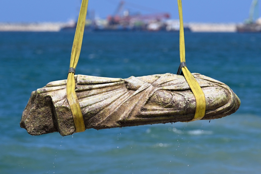 A crane pulls an artifact from the waters at Abu Qir bay in Alexandria on August 21, 2025, as part of an event organised by the Ministry of Tourism and Antiquities to recover sunken antiquities. — AFP pic 