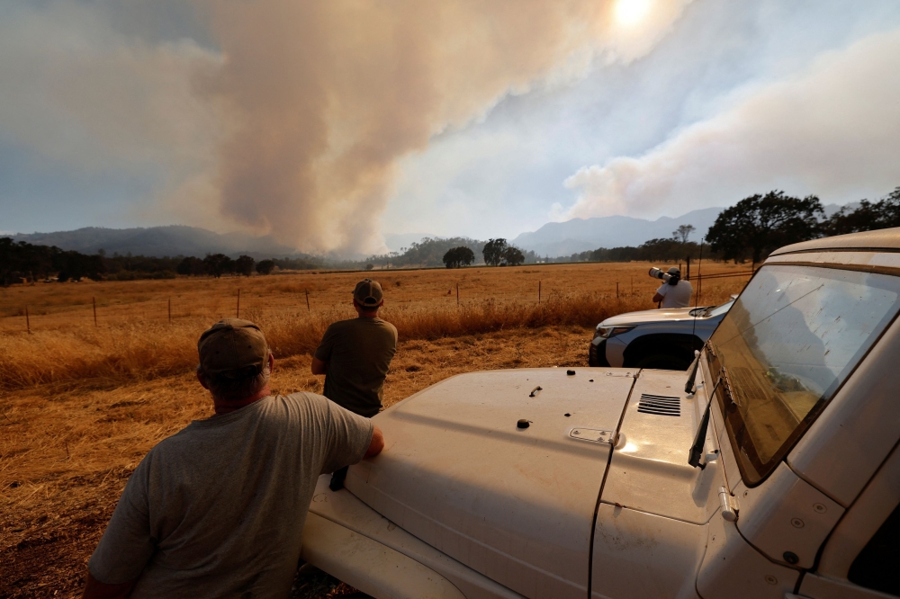 Residents watch smoke rising from the Pickett Fire in Pope Valley, Napa County, California August 22, 2025. Officials have encouraged anyone living in or near the burn scar to have their blood tested for lead poisoning. — Reuters pic